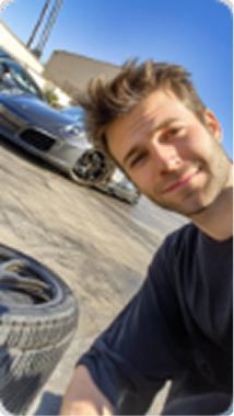Technician checking tire pressure with gauge